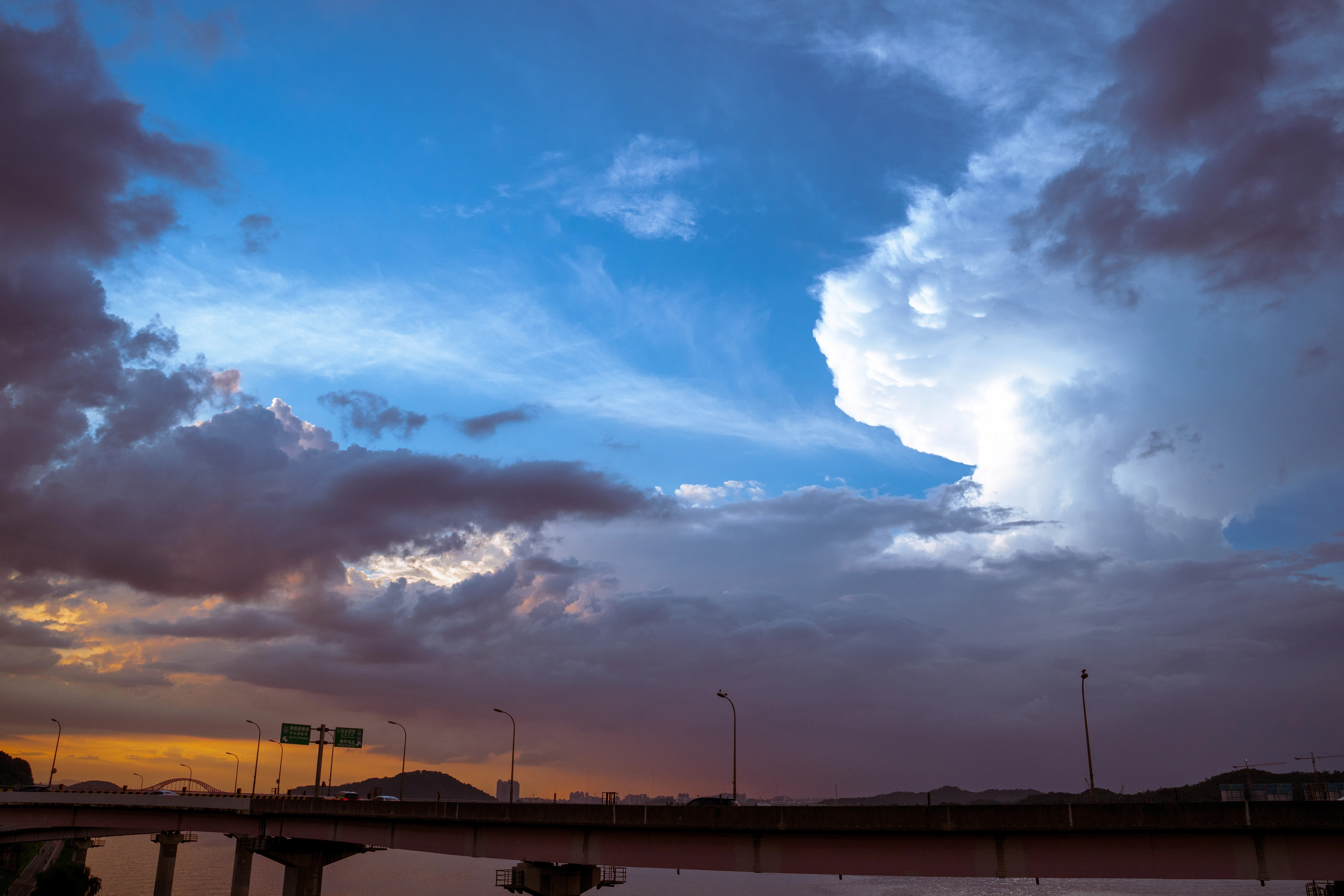 Dramatic Skies Over Urban Riverside at Dusk